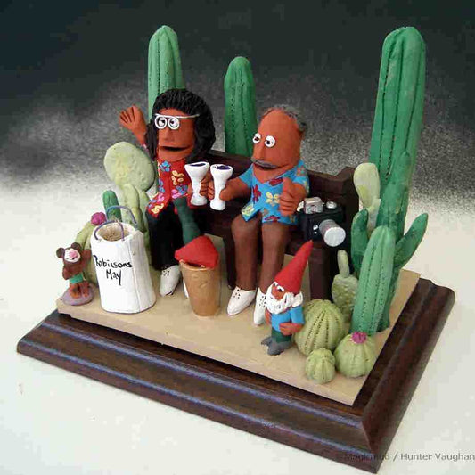 Custom made Anniversary Gift...Clay caricature of them amongst their cacti, his camera, her garden knome, toasting with champagne on ice...