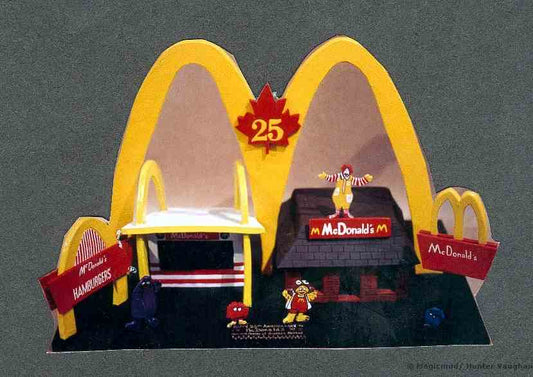 McDonalds 25th Anniversary Canada's First McD's next to a contemporary model