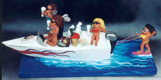 Personalized sports figurine of Mr. Cool in his yacht wearing a gold chain and shades, and his "babe" is sporting a big diamond while cruisin' in their yacht...the Good Life...Immortalized!
