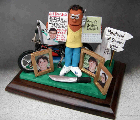 Dad's 50th Birthday clay caricature, with his mtn. bike, family photos,destination post and handy machete