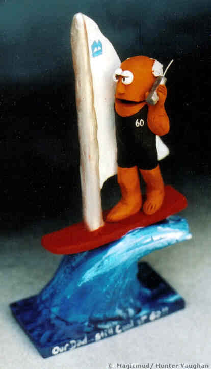 windsurfer figurine on a wave, with his cel phone and business logo on sail