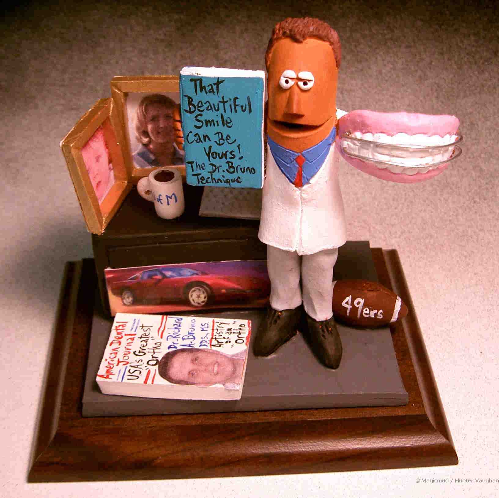 Personalized Orthodontist Statue, photos of wife and son on his desk, along with his laptop, football, coffee, and corvette photo too...an unusual gift idea for the office.