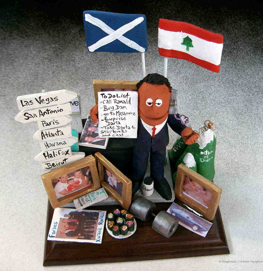 A personalized statue of him with pictures of his newborn, Porsche,sushi,weights,travel destinations, flags and much more...what a great momento from an employee to her boss...the Ultimate Office Gift!